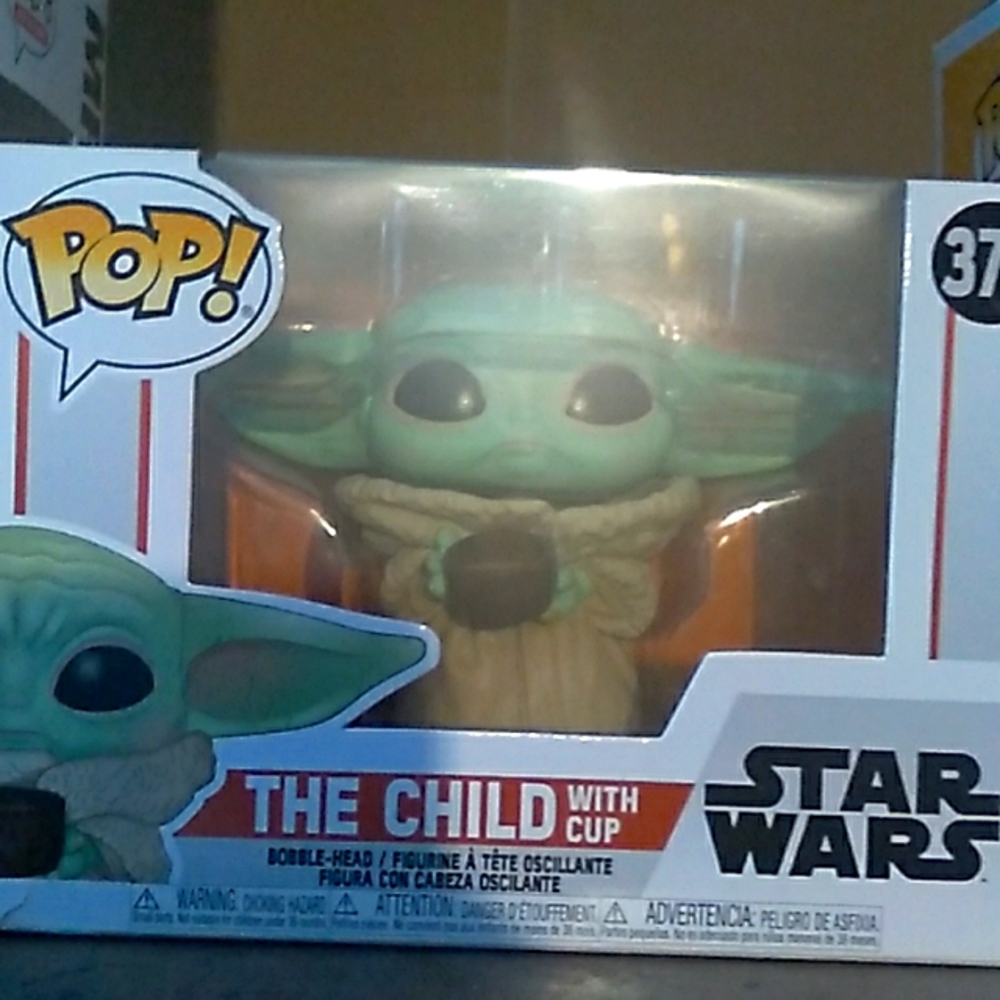 The baby Yoda with cup funko pop